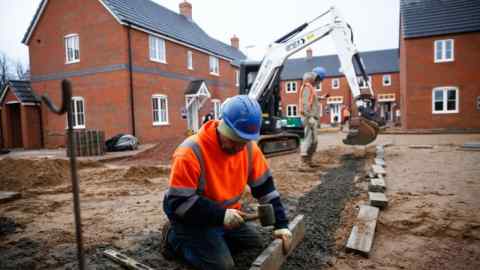 Workers building residential properties