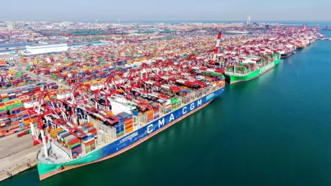 Getty Images Cargo ships load and unload foreign trade containers at the fully automated terminal of Qingdao Port in China.