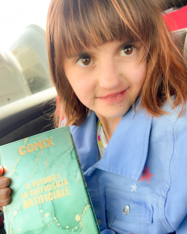 Girl holding a book.