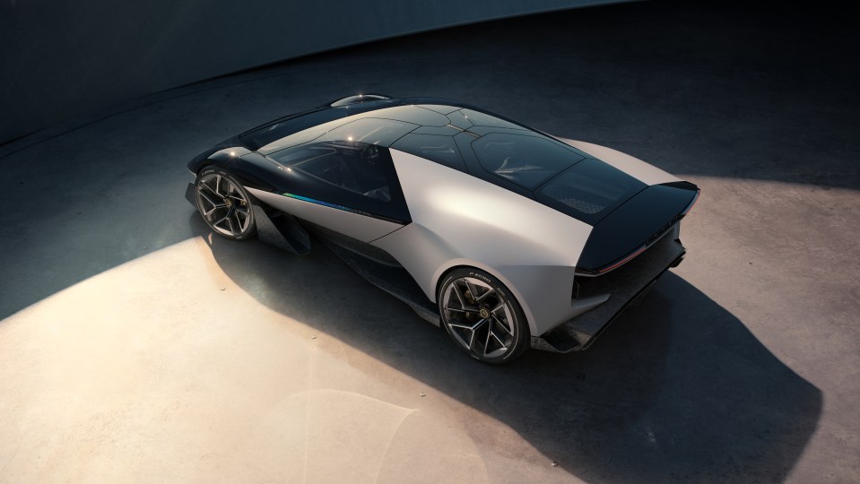 a black and white car is parked on a concrete surface