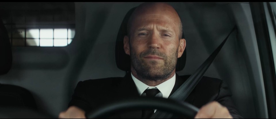 Jason Statham driving a car.