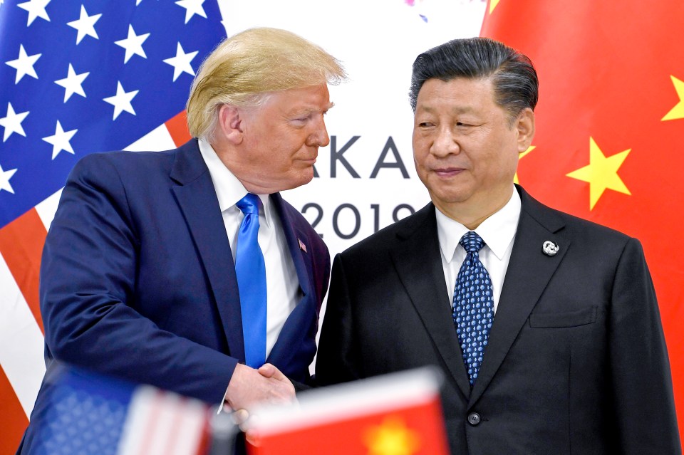 Donald Trump and Xi Jinping shaking hands.