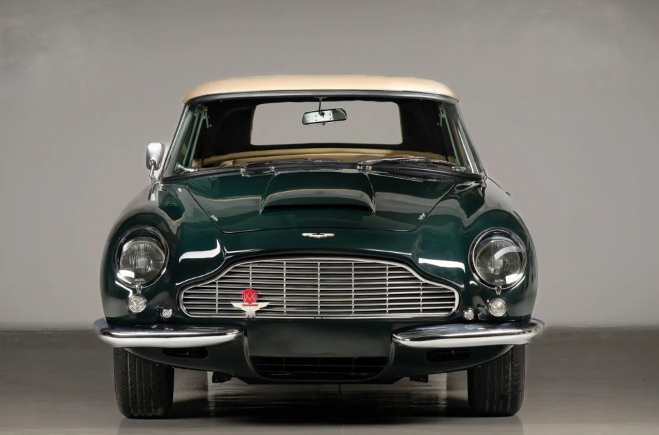 Front view of a dark green Aston Martin DB Short-Chassis Volante convertible.