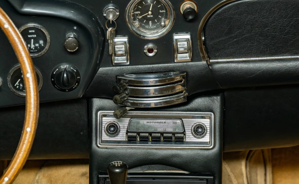 Dashboard of a classic Aston Martin DB Short-Chassis Volante with Motorola radio.