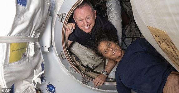 FILE - In this photo provided by NASA, Boeing Crew Flight Test astronauts Butch Wilmore, left, and Suni Williams pose for a portrait inside the vestibule between the forward port on the International Space Station's Harmony module and Boeing's Starliner spacecraft on June 13, 2024. (NASA via AP, File)