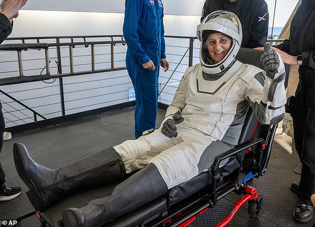 Sunita Williams gives a thumbs-up after emerging from the capsule. Following their initial checks, the astronauts will be taken to their crew quarters at NASA's Johnson Space Center in Houston for several more days of routine health checks