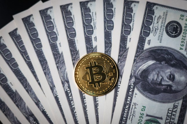 Mandatory Credit: Photo by Artem Priakhin/SOPA Images/Shutterstock (15125157m) In this photo illustration, the new Bitcoin token is photographed on US $100 bills featuring Benjamin Franklin. US President Donald Trump on Thursday, January 23, ordered the creation of a cryptocurrency task force tasked with developing proposals for new regulations for digital assets and exploring the possibility of creating a national cryptocurrency reserve. Photo illustrations in Russia - 29 Jan 2025