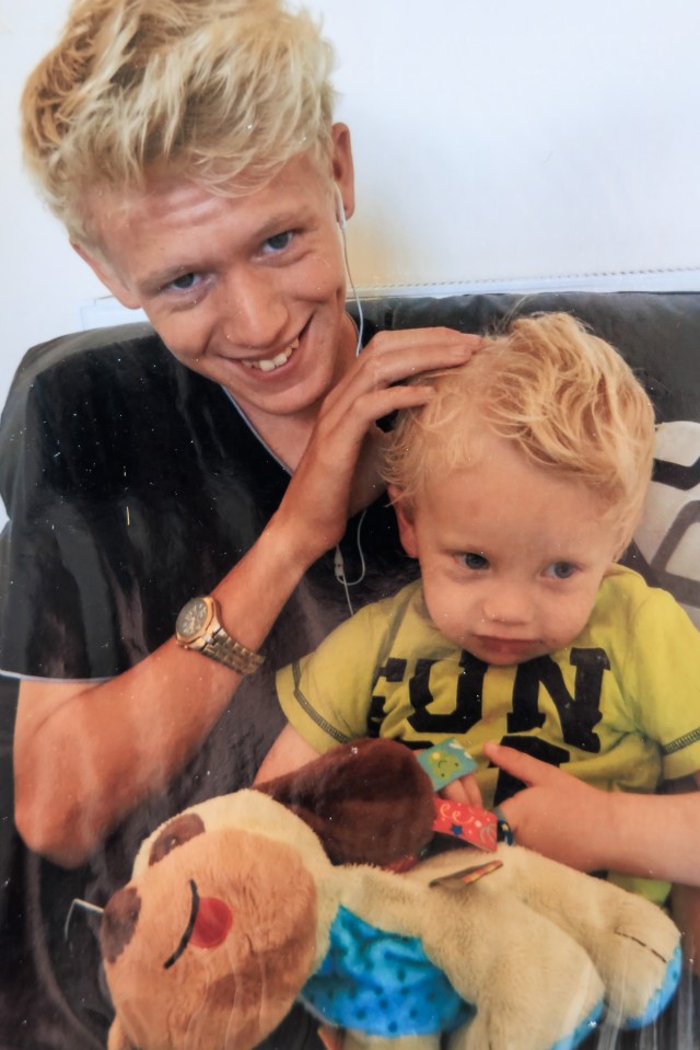 Photo of two brothers, one older and one younger, hugging a stuffed animal.