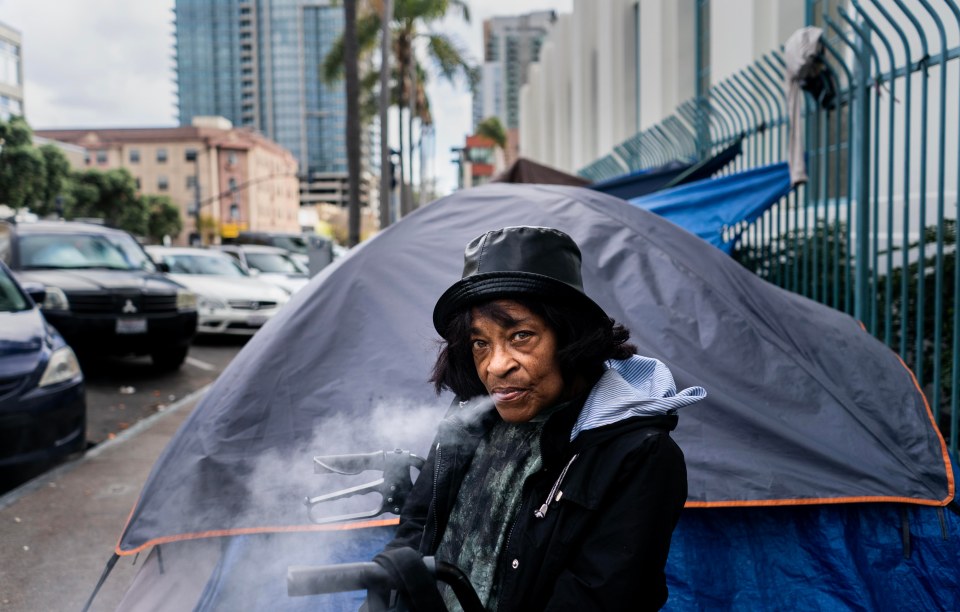 Homeless woman smoking outside her tent in San Diego.