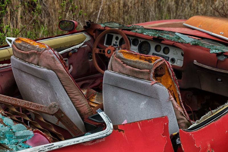 Interior of a wrecked red car.