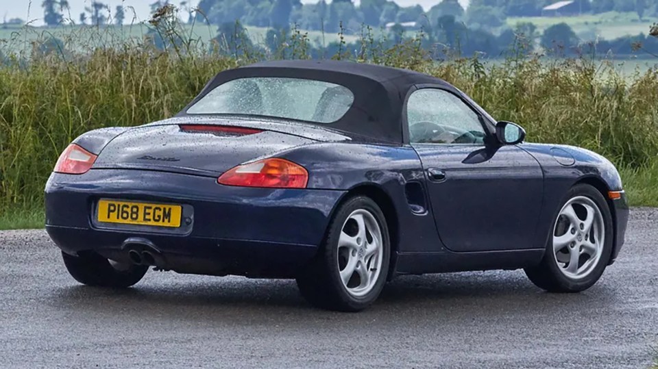 Rear view of a dark blue Porsche Boxster S (986).