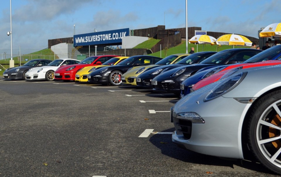 Row of Porsches parked at Silverstone.