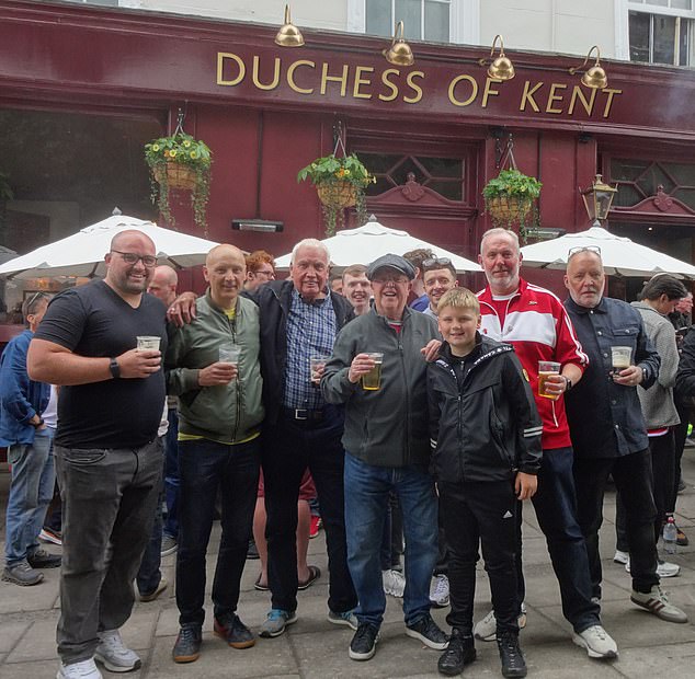 Pete Murphy and his son Barney, second and first left, with friends at their favourite pub near Arsenal's ground