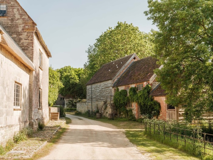 Quiet country lane lined with old stone and brick buildings