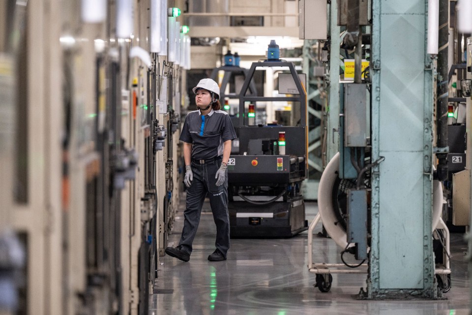 A Nissan employee in a factory.