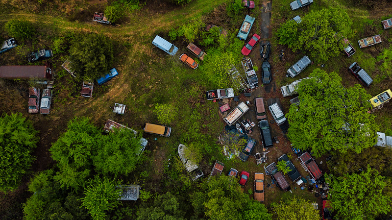 Aerial view of an abandoned graveyard of luxury cars in Arkansas.